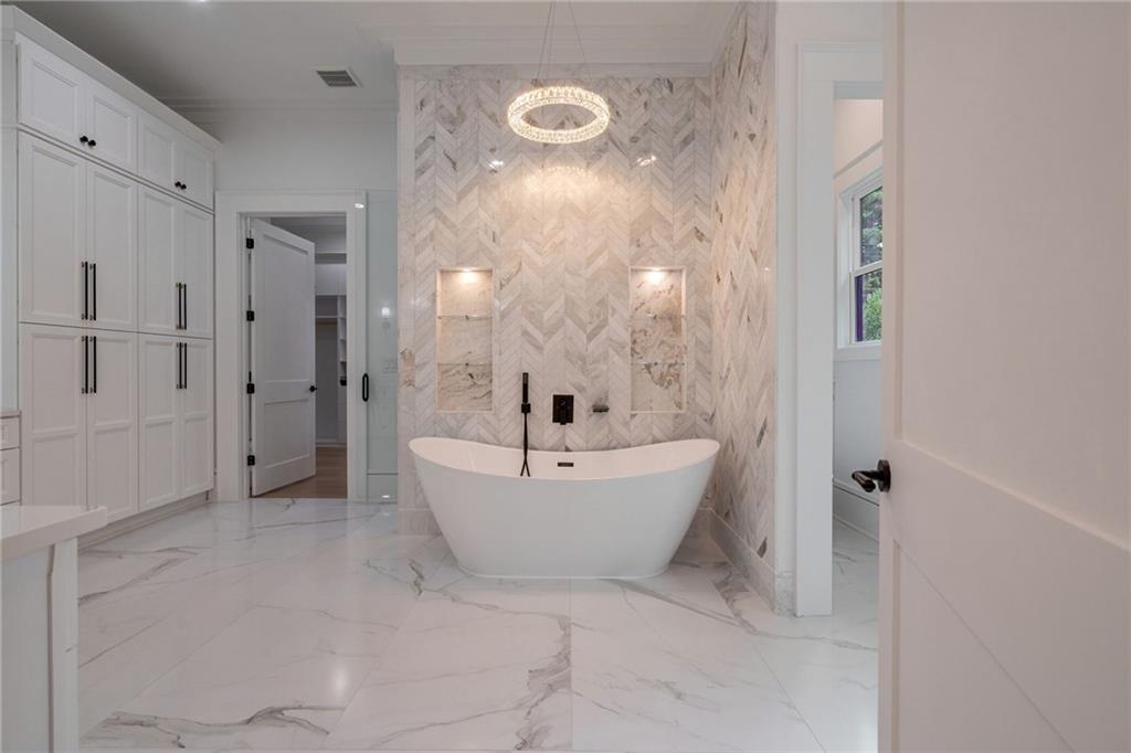 4459 Grady Smith Road Loganville, GA 30052 - Photo 55 of 124 a bathroom with a bathtub and shower