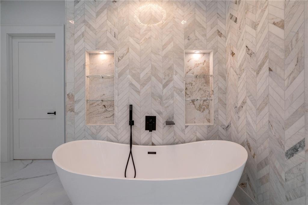 4459 Grady Smith Road Loganville, GA 30052 - Photo 58 of 124 a bathroom with a bathtub and shower