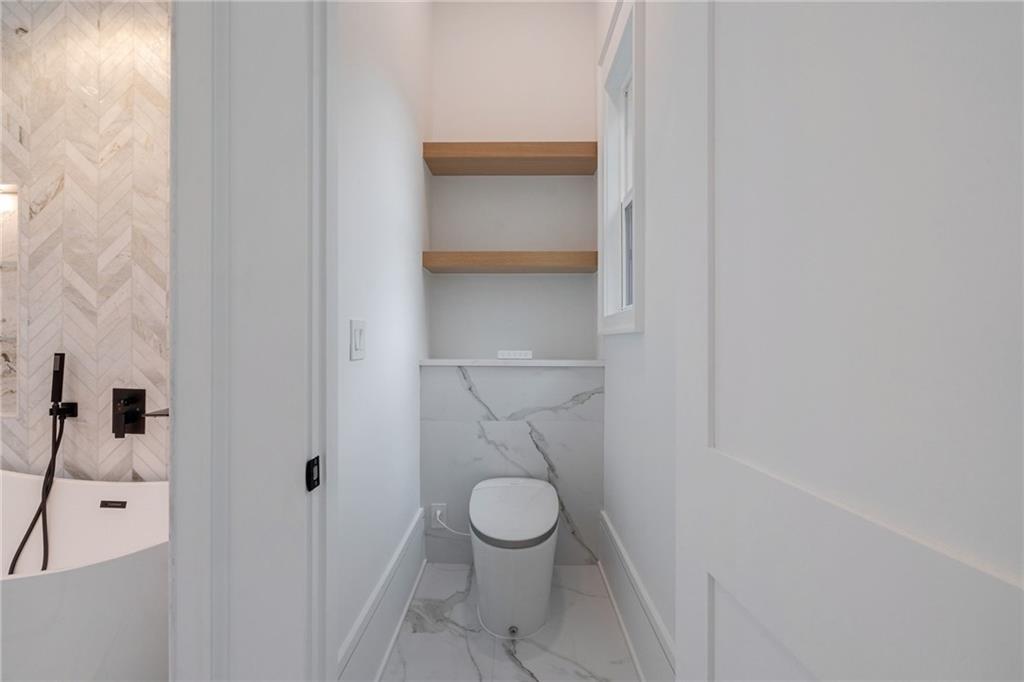 4459 Grady Smith Road Loganville, GA 30052 - Photo 62 of 124 a bathroom with a toilet and a sink