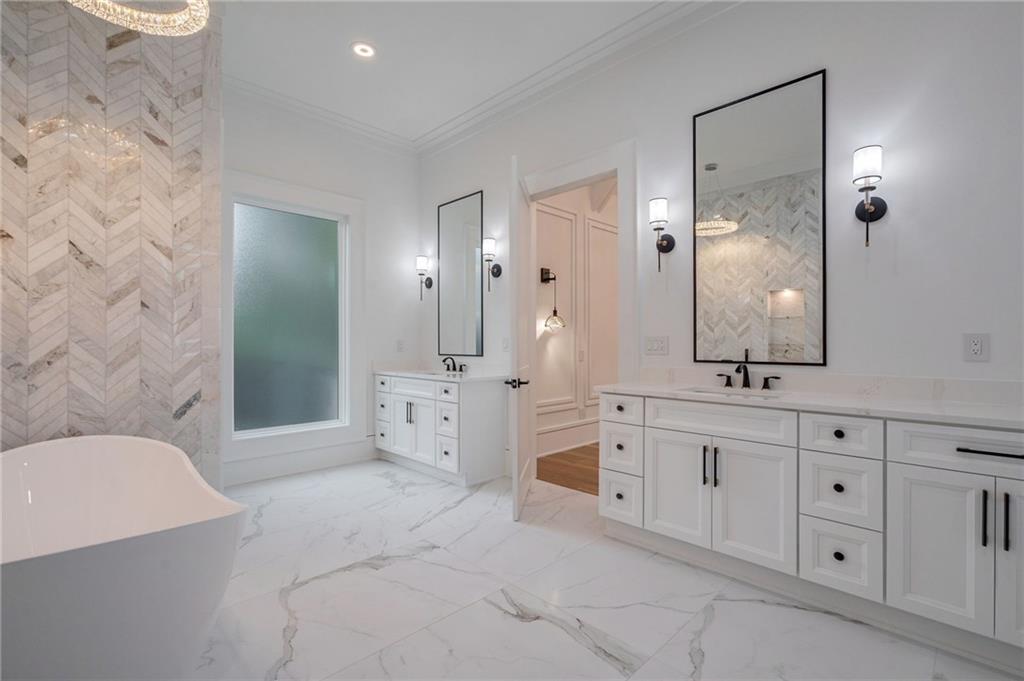 4459 Grady Smith Road Loganville, GA 30052 - Photo 63 of 124 a spacious bathroom with a double vanity sink a mirror and a shower
