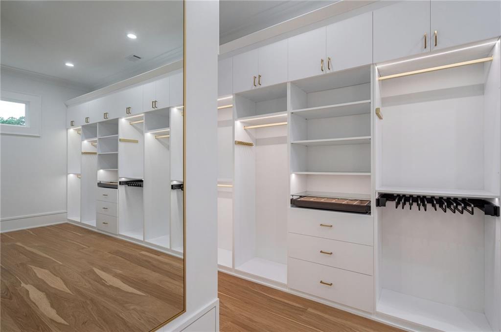 4459 Grady Smith Road Loganville, GA 30052 - Photo 65 of 124 a view of walk in closet with empty racks