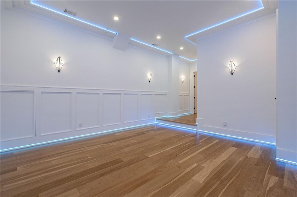 4459 Grady Smith Road Loganville, GA 30052 - Photo 7 of 124 an empty room with wooden floor and windows