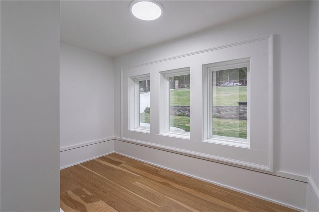 4459 Grady Smith Road Loganville, GA 30052 - Photo 76 of 124 a view of empty room with wooden floor and fan