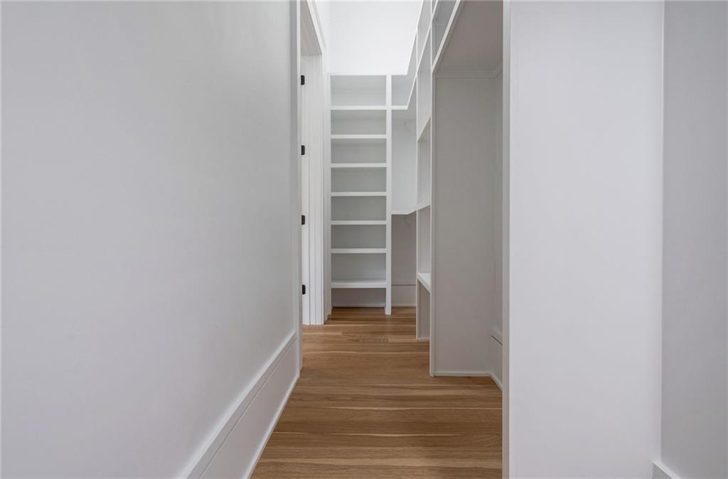 4459 Grady Smith Road Loganville, GA 30052 - Photo 77 of 124 a view of a hallway with wooden floor and closet