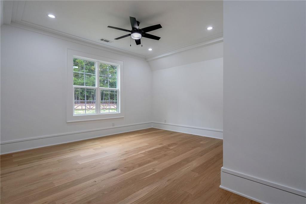 4459 Grady Smith Road Loganville, GA 30052 - Photo 83 of 124 an empty room with wooden floor and windows