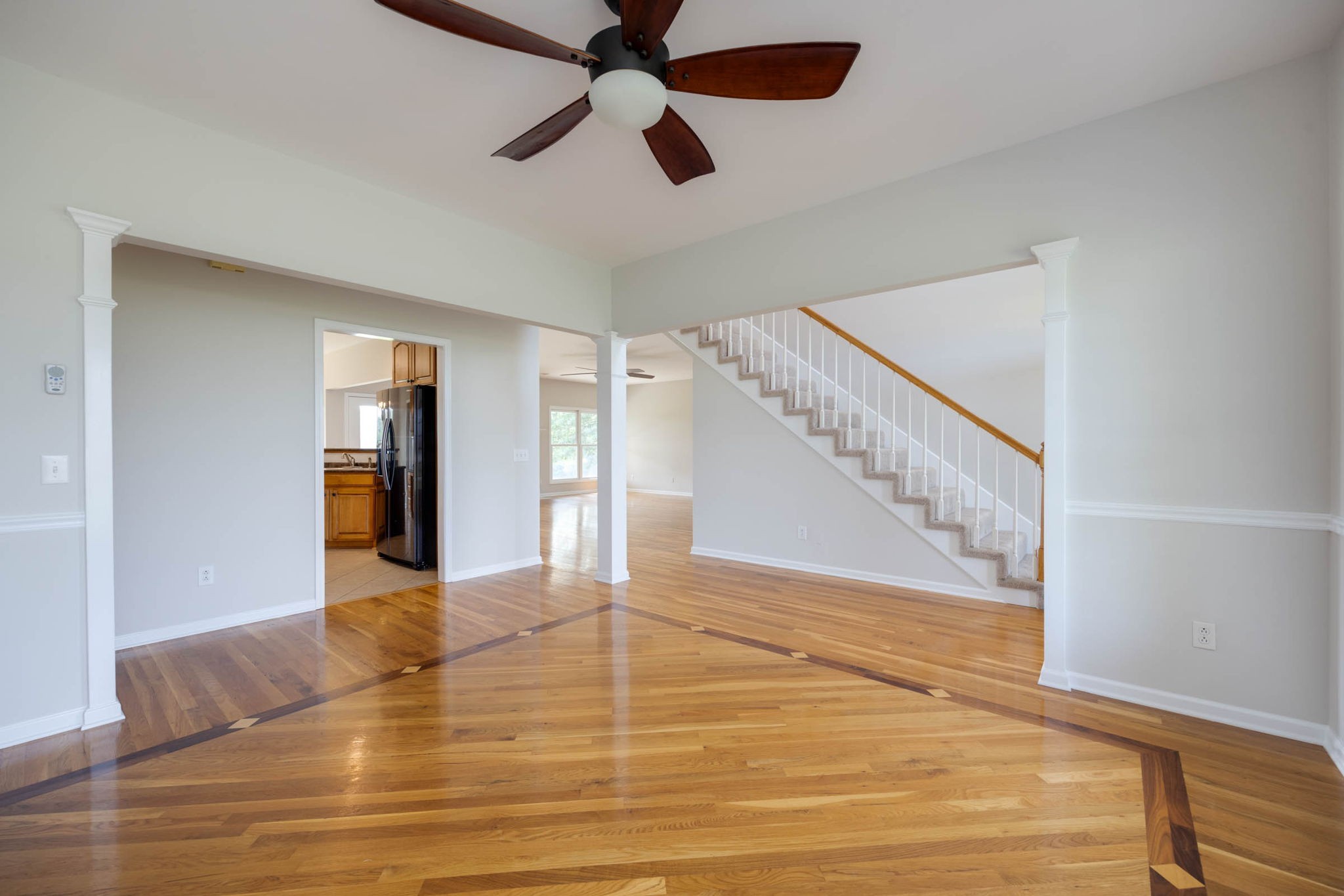 7486 Flewellyn Road Cedar Hill, TN 37032 - Photo 9 of 45 a view of an empty room with wooden floor and a ceiling fan