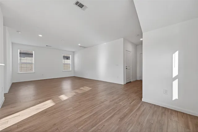 a view of kitchen with wooden floor electronic appliances and window