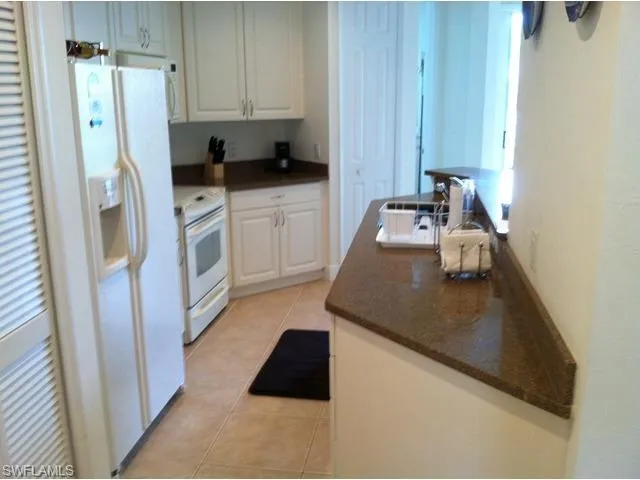 a kitchen with stainless steel appliances a refrigerator a sink a stove a counter space and cabinets