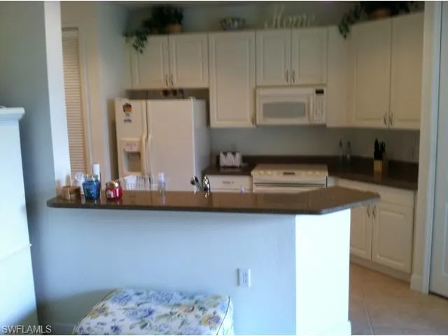 a kitchen with a sink cabinets and appliances