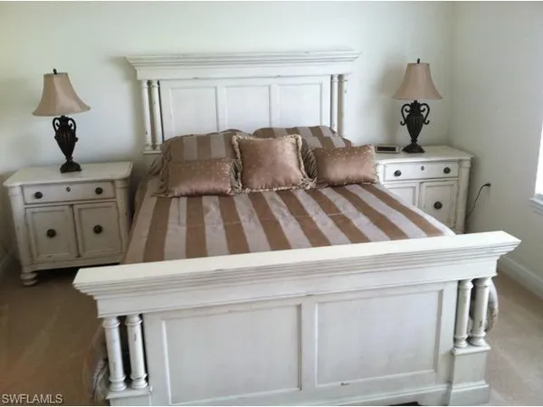 a living room with a bed furniture and a window