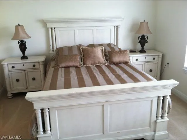 a living room with a bed furniture and a window