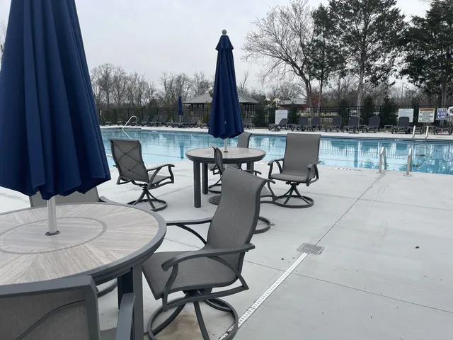 a view of a patio with a table and chairs