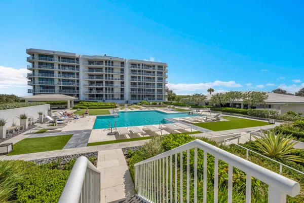 a view of swimming pool with outdoor seating and a yard
