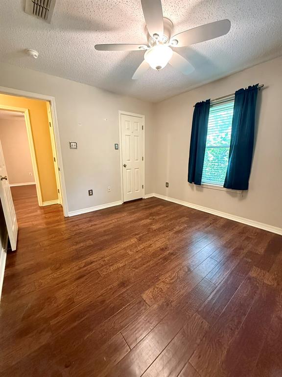 11535 Timber Ridge Drive Keithville, LA 71047 - Photo 19 of 39 a view of an empty room with window and wooden floor