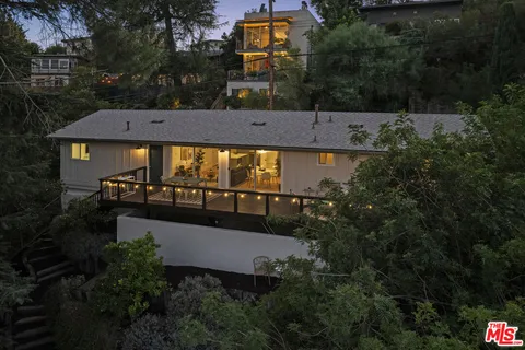 an aerial view of a house with swimming pool outdoor seating and yard