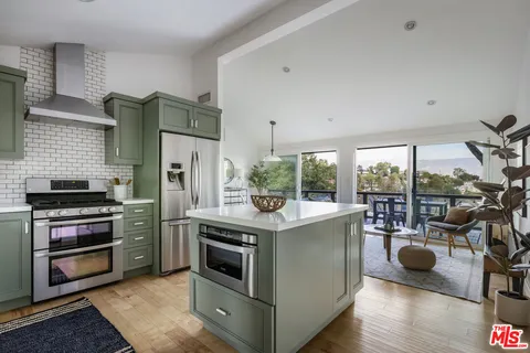 a kitchen with a stove and a refrigerator