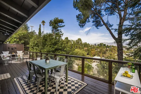 a view of a chairs and table in the balcony