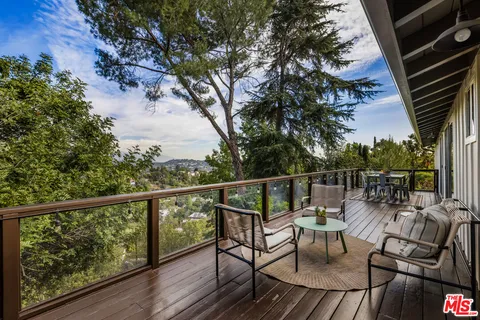 a view of balcony with wooden floor and outdoor seating