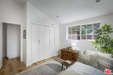 a bedroom with furniture and a window
