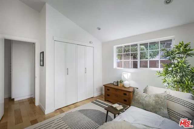 a bedroom with furniture and a window