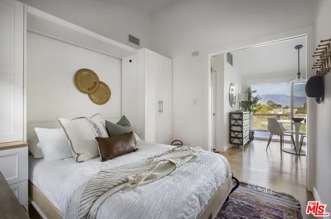 a bedroom with bed and chair