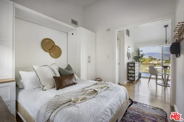 a bedroom with bed and chair