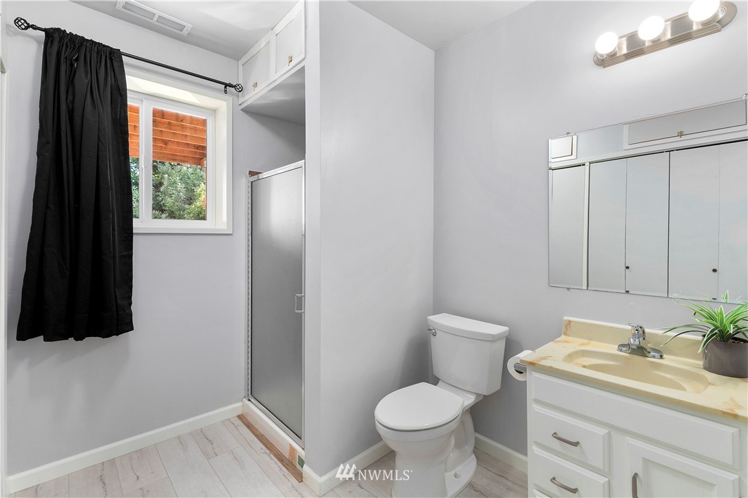 3113 Southeast 18th Street Renton, WA 98058 - Photo 22 of 30 a bathroom with a toilet sink and mirror