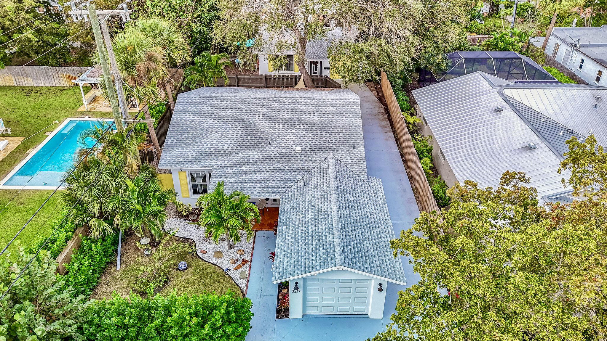 a aerial view of a house with a yard and potted plants