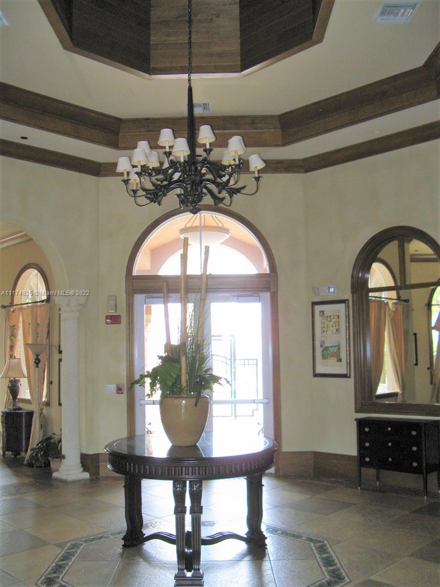 4402 Southwest 160th Avenue, Unit 925 Miramar, FL 33027 - Photo 17 of 34 a view of a livingroom with furniture mirror and a chandelier