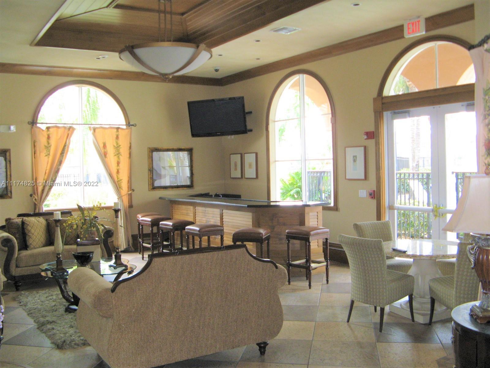 4402 Southwest 160th Avenue, Unit 925 Miramar, FL 33027 - Photo 18 of 34 a living room with large window and a chandelier