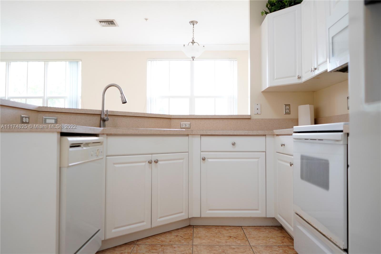 4402 Southwest 160th Avenue, Unit 925 Miramar, FL 33027 - Photo 6 of 34 a kitchen with white cabinets and sink