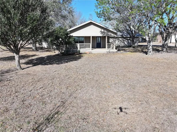 a view of a house with a yard covered in snow
