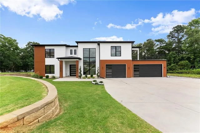 a front view of house with yard and green space