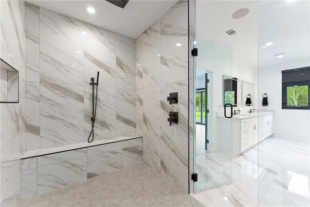 a kitchen with stainless steel appliances a dining table chairs stove and refrigerator