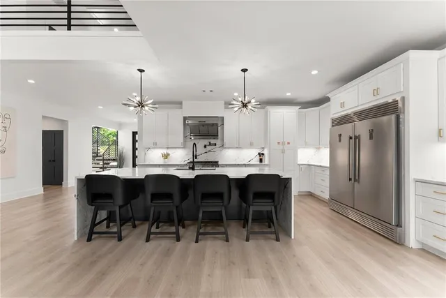 a bathroom with a sink vanity mirror and shower