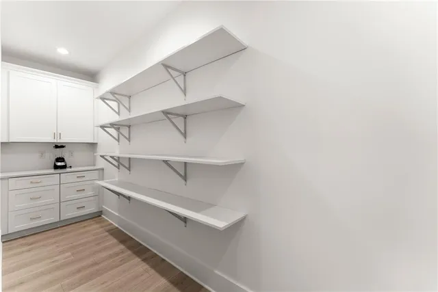 a spacious bedroom with a bed and a window