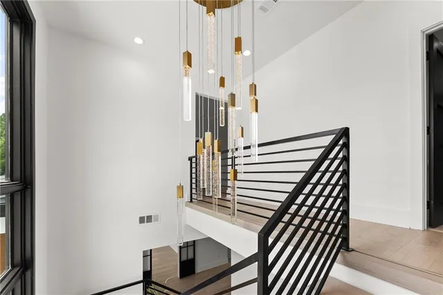 a bedroom with a large bed and a chandelier