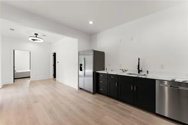 a view of hall way with furniture and wooden floor