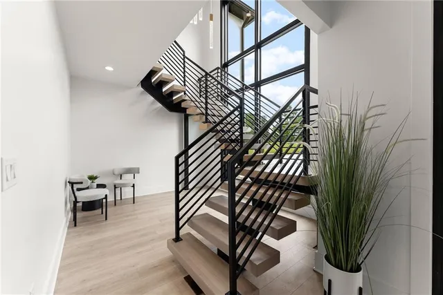 a spacious bedroom with a large bed and a large window