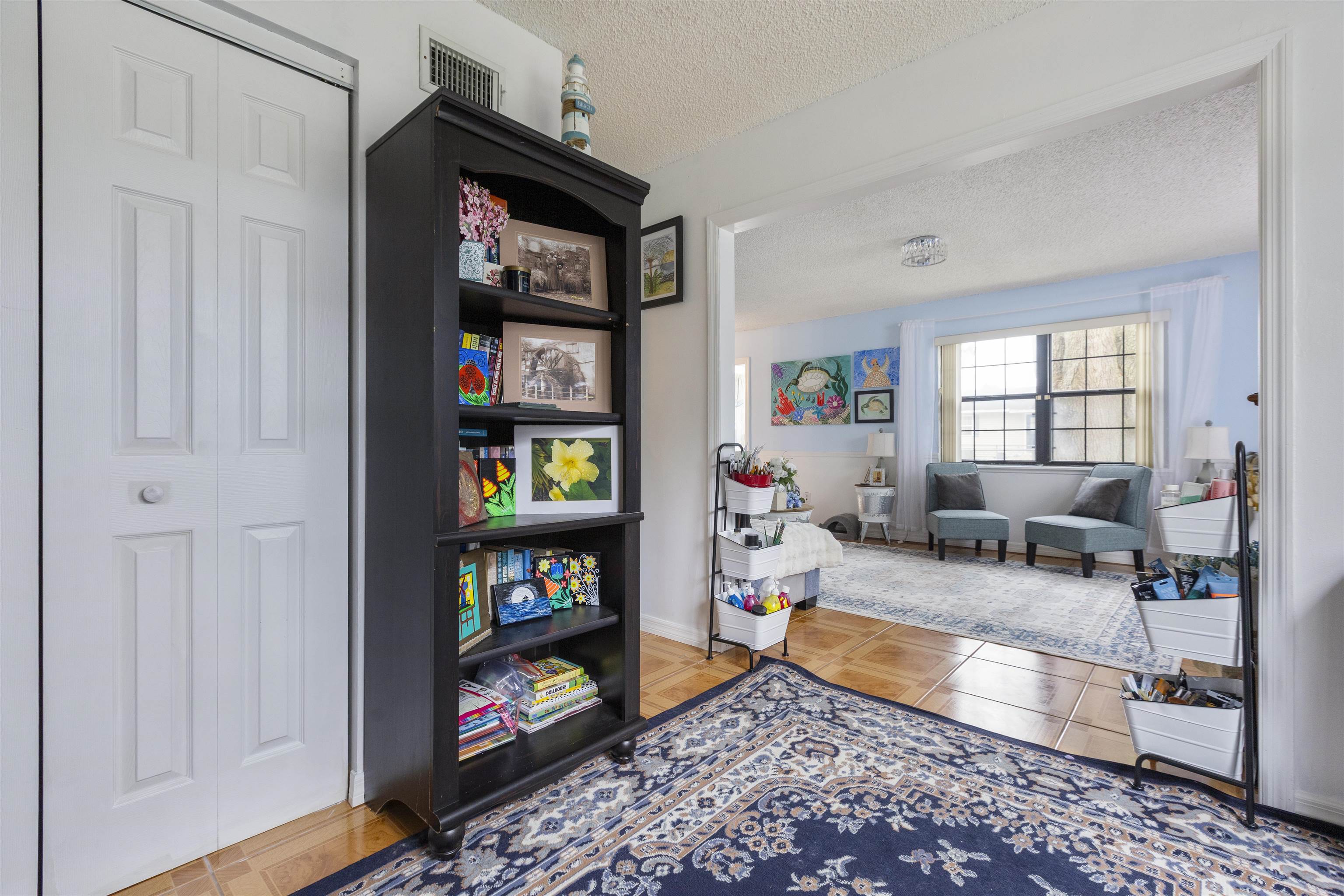 4240 New Hampshire Road Elkton, FL 32033 - Photo 19 of 35 a living room with furniture and a book shelf