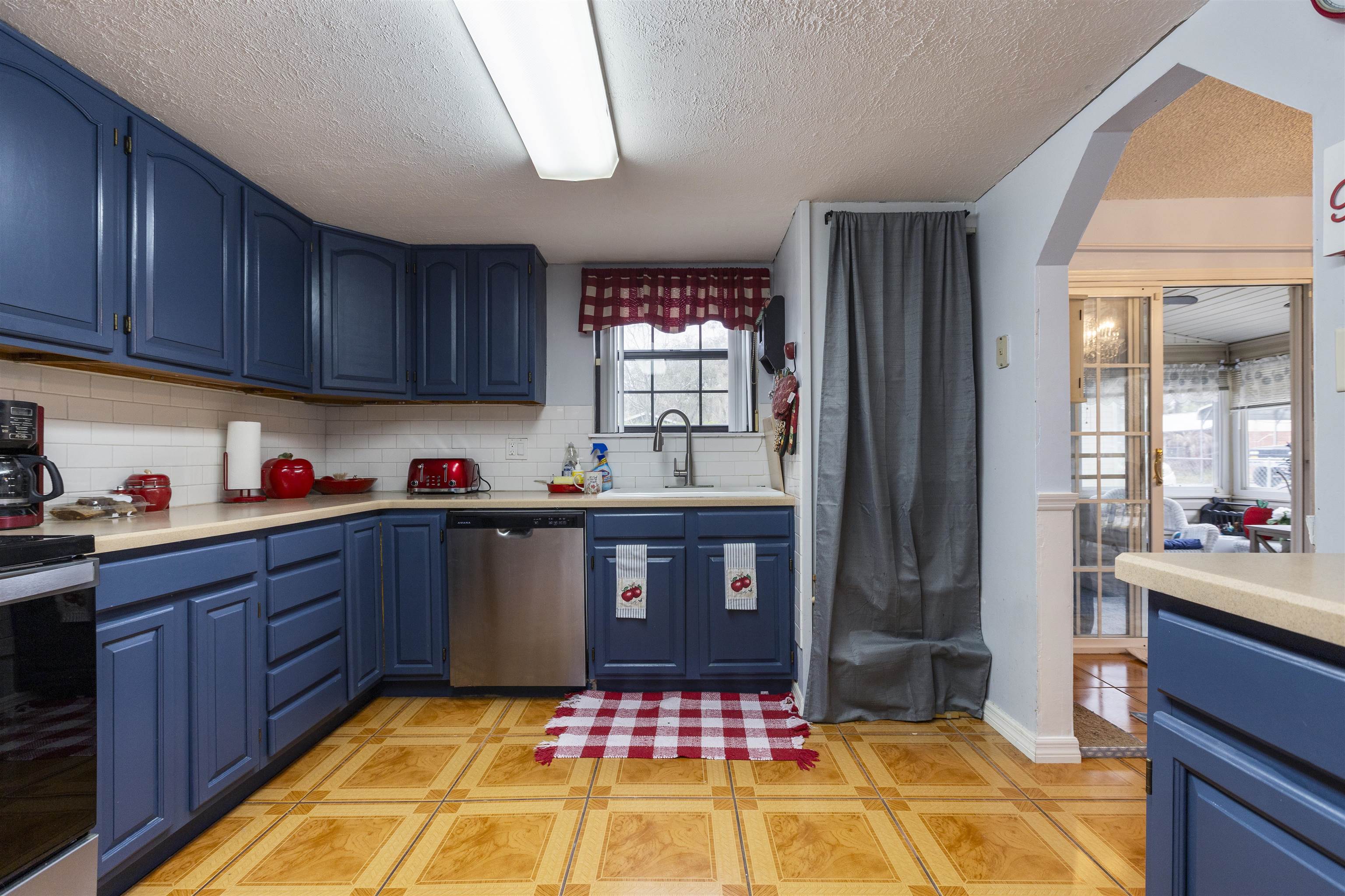 4240 New Hampshire Road Elkton, FL 32033 - Photo 24 of 35 a kitchen with granite countertop a refrigerator stove and sink