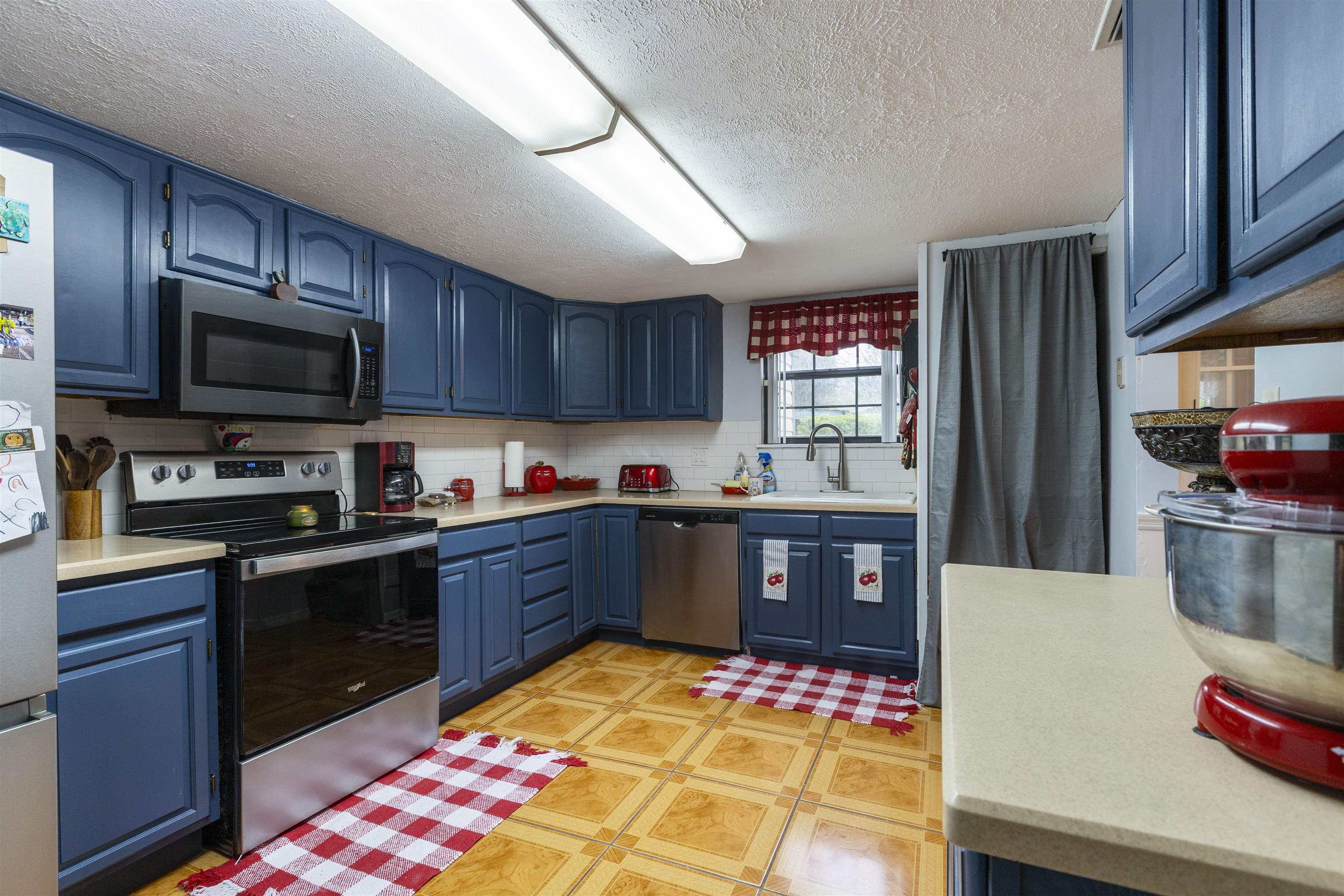 4240 New Hampshire Road Elkton, FL 32033 - Photo 25 of 35 a kitchen with stainless steel appliances granite countertop a sink stove microwave and refrigerator