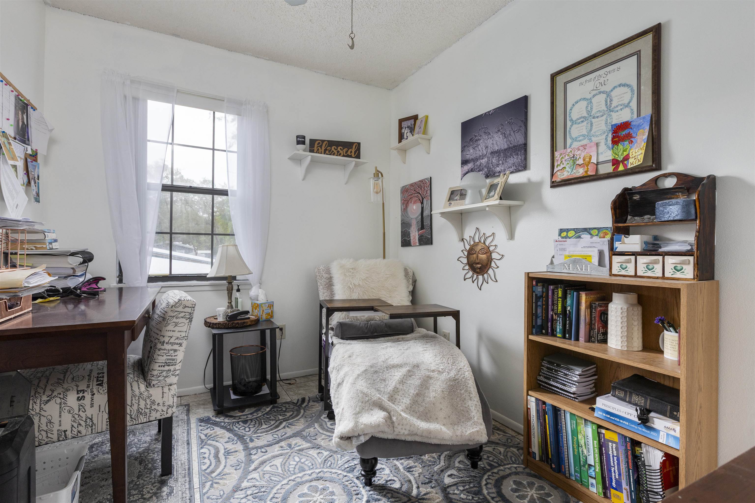 4240 New Hampshire Road Elkton, FL 32033 - Photo 29 of 35 a bedroom with furniture a book shelf and a book shelf