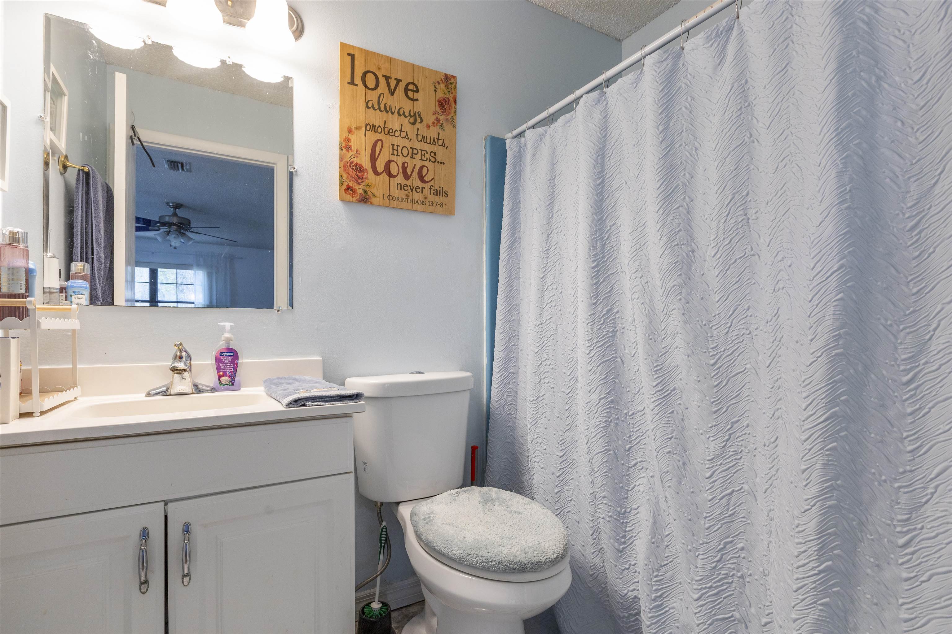 4240 New Hampshire Road Elkton, FL 32033 - Photo 30 of 35 a bathroom with a toilet sink and mirror