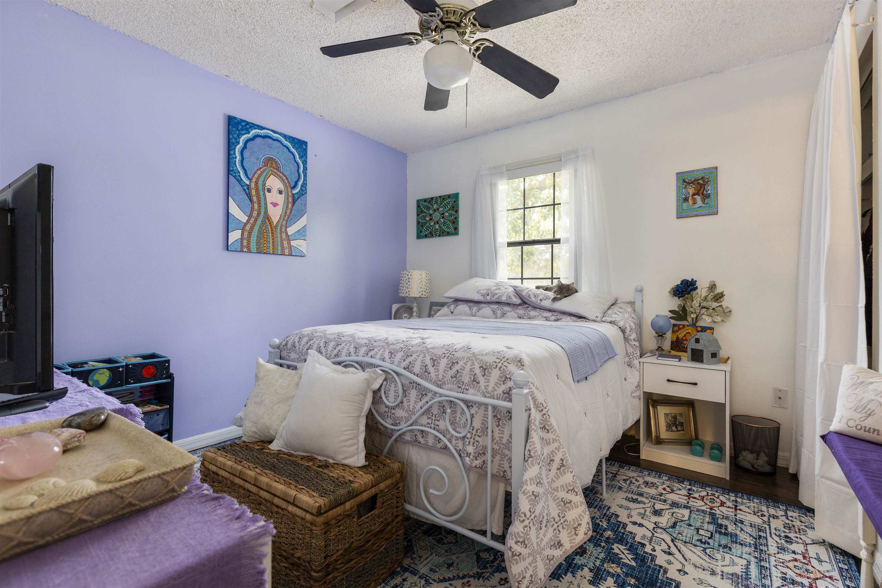 4240 New Hampshire Road Elkton, FL 32033 - Photo 31 of 35 a bedroom with a bed and wooden floor