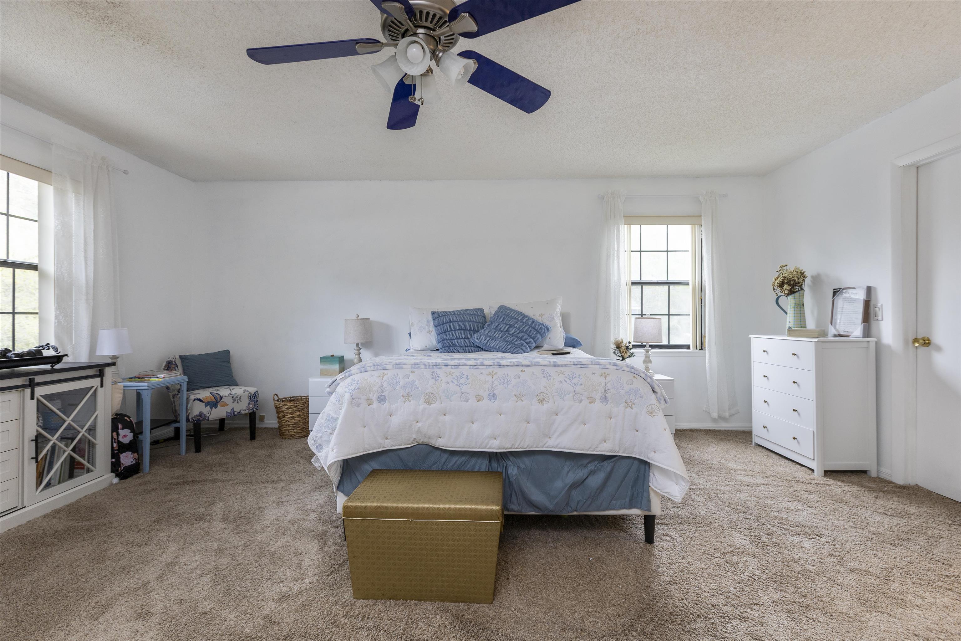 4240 New Hampshire Road Elkton, FL 32033 - Photo 32 of 35 a bedroom with a bed and a chandelier