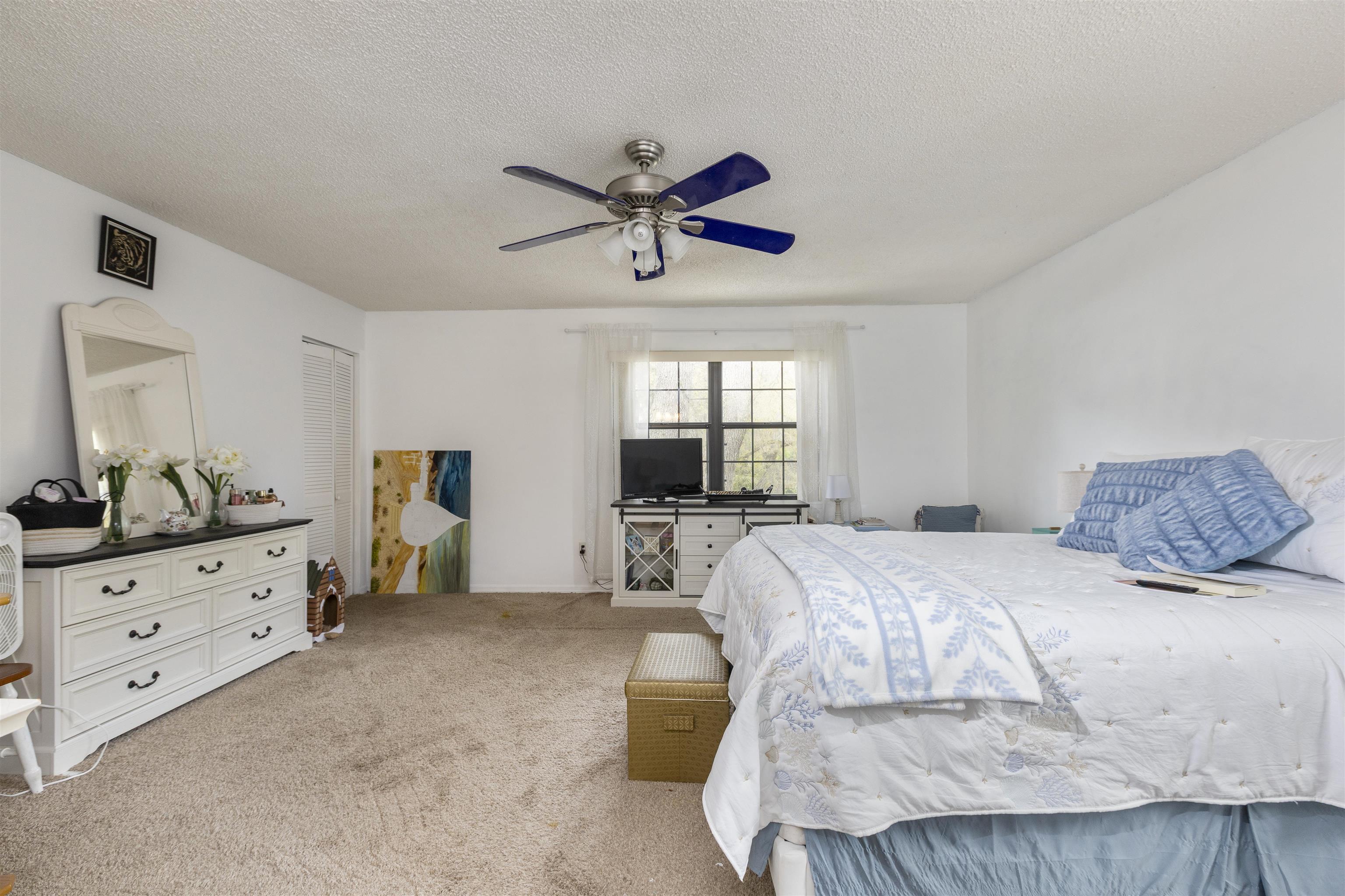 4240 New Hampshire Road Elkton, FL 32033 - Photo 33 of 35 a bedroom with a bed and a dresser