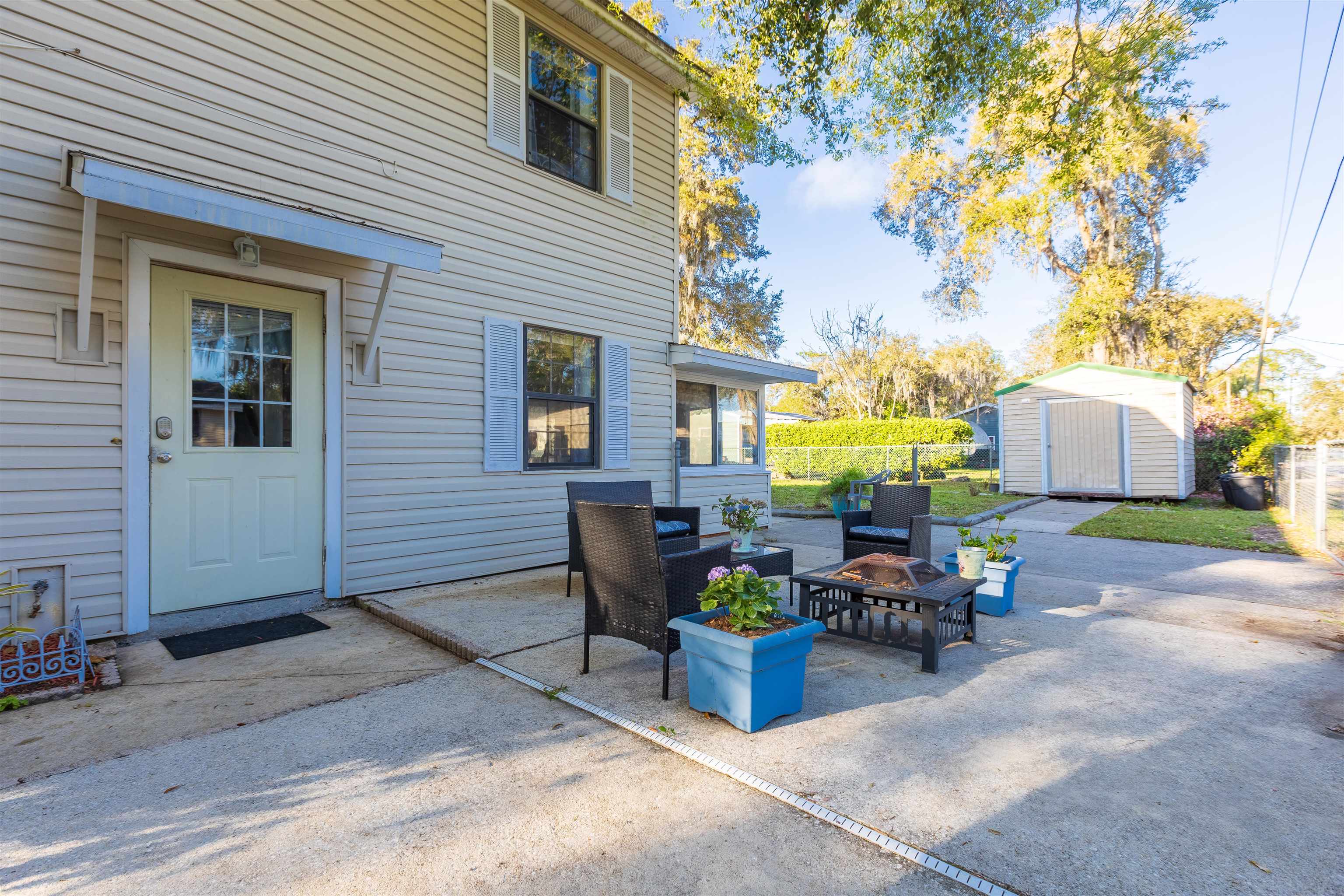 4240 New Hampshire Road Elkton, FL 32033 - Photo 35 of 35 a view of a patio with table and chairs and potted plants