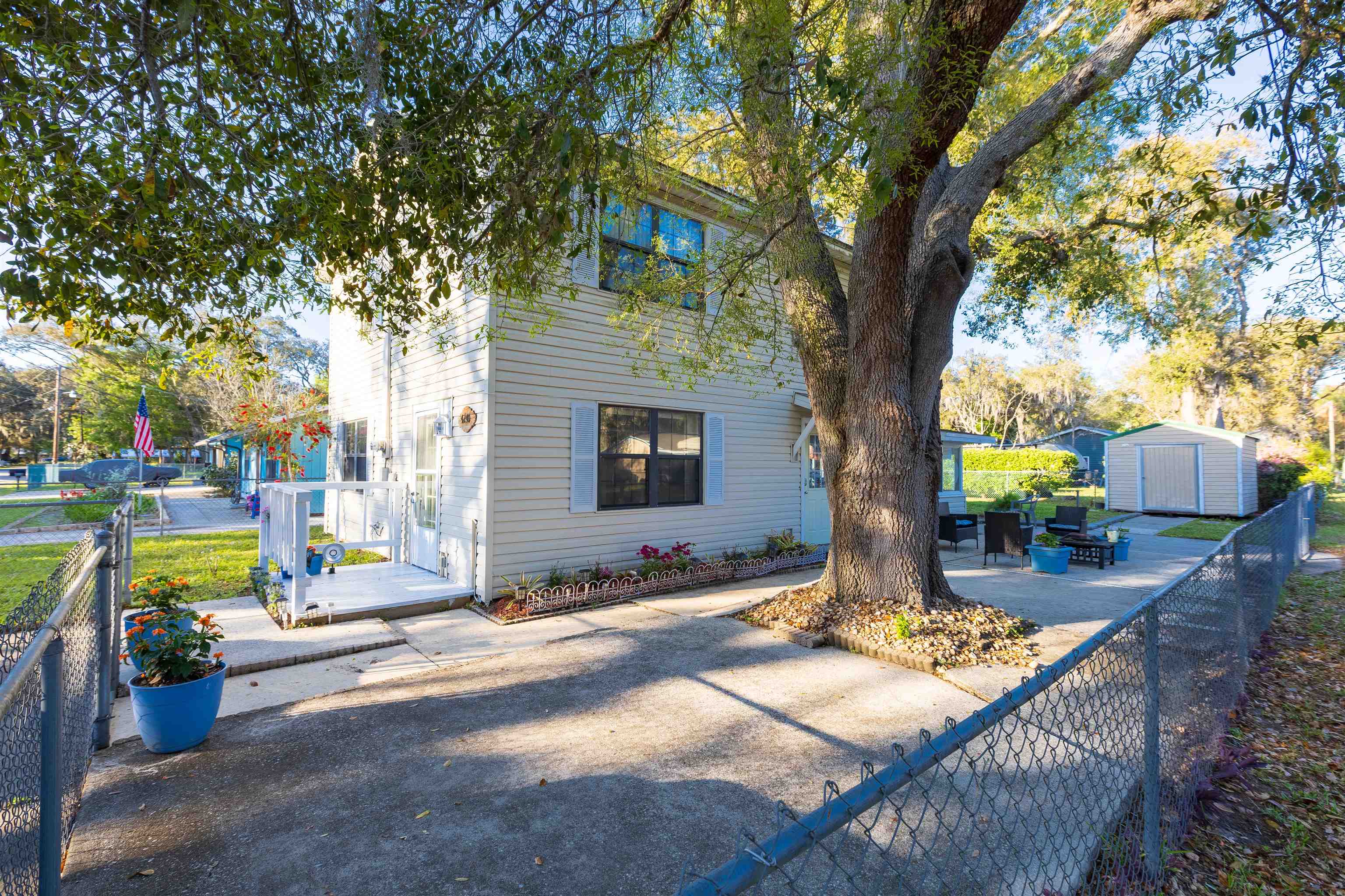 4240 New Hampshire Road Elkton, FL 32033 - Photo 10 of 35 a view of a patio with table and chairs and potted plants