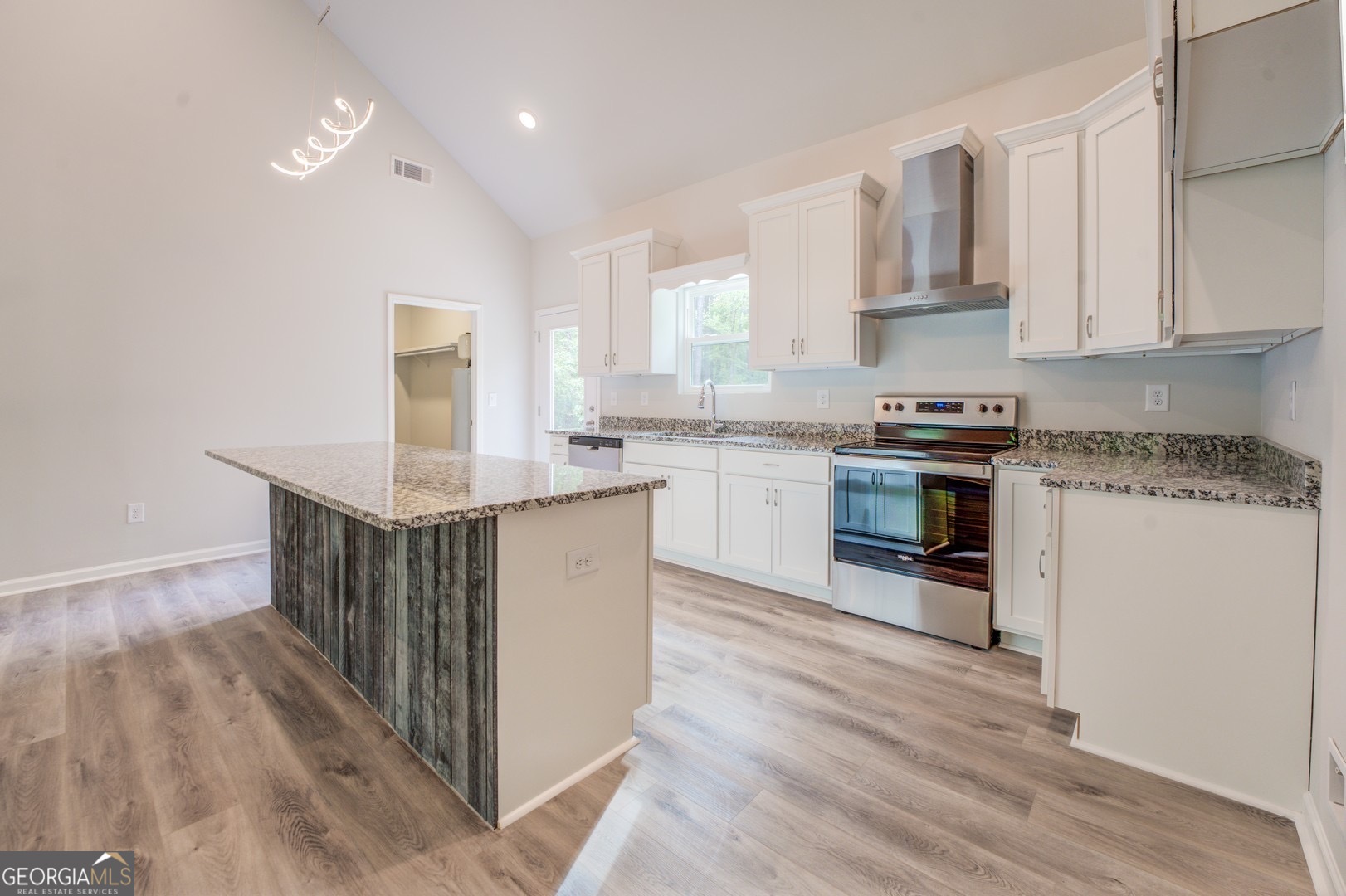 359 Whippoorwill Road Monticello, GA 31064 - Photo 11 of 37 a kitchen with stainless steel appliances granite countertop a stove top oven a sink dishwasher and white cabinets with wooden floor